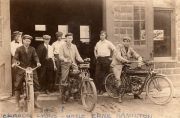 Front row on bikes, left Claude Arthur Lyons, center Ernest Hamilton, right William Colegrove. Depicted with their Flying Merkels.  They competed as a team in board track racing.  The date is not known precisely but is probably 1911 or 1912.  The photo was taken in front of Backus Garage on West Waters St in Smethport Pa. By courtesy of Kathryn A. Lyons, from Hamburg, NY, granddaughter of Claude. (CC By 4.0).  More historical information can be found at the Semthport website: http://www.smeth porthistory.org /w.waterstreet /backus /backus% 20garage/ earlybackus garage.html <http://www.smethporthistory.org /w.waterstreet/backus /backus%20garage/ earlybackusgarage.html>